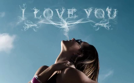 HD artistic desktop wallpaper with a woman exhaling smoke that forms the words I LOVE YOU against a clear blue sky backdrop, capturing a theme of love.