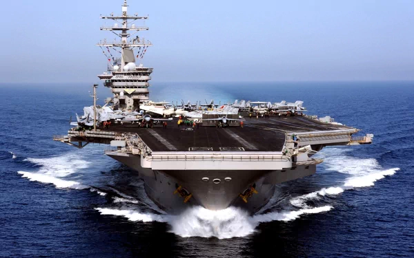 HD desktop wallpaper featuring the USS Dwight D. Eisenhower (CVN-69), a U.S. Navy aircraft carrier and warship, sailing through the ocean.