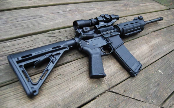 A close-up view of a man-made assault rifle resting on wooden planks, showcasing its sleek design and features for a high-definition desktop wallpaper.