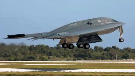 A stealth military aircraft takes off, showcasing its sleek design against a clear sky. This captivating image serves as a stunning 4K Ultra HD PC desktop wallpaper and background.