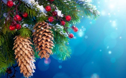 HD desktop wallpaper featuring a festive holiday scene with pine cones, vibrant red berries, and snow-dusted evergreen branches against a bright blue, sparkling background.
