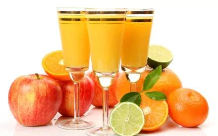 HD PC desktop wallpaper featuring fresh citrus fruits and three glasses filled with bright orange juice, highlighting vibrant colors in a food and drink theme.