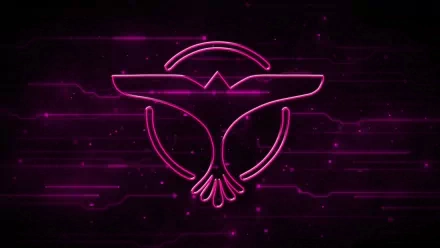 A vibrant purple background featuring the iconic DJ Tiësto symbol, set against a dynamic, abstract pattern, creating an energetic and modern music-themed desktop wallpaper.