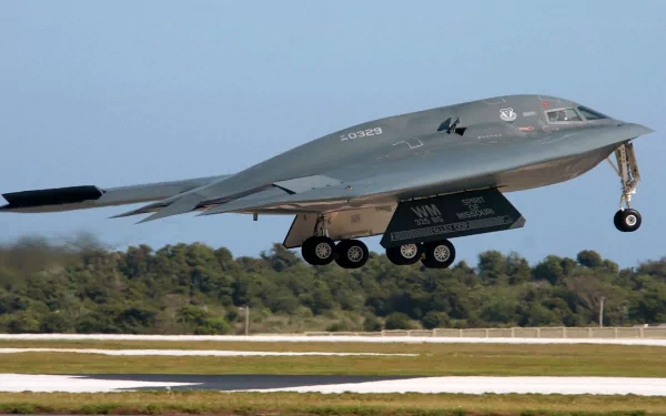 A stealth military aircraft takes off, showcasing its sleek design against a clear sky. This captivating image serves as a stunning 4K Ultra HD PC desktop wallpaper and background.