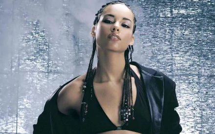 HD PC desktop wallpaper featuring Alicia Keys in a stylish black outfit with braided hair, set against a shimmering silver background, highlighting her musical presence.