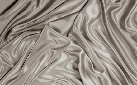 HD PC desktop wallpaper featuring an abstract texture of smooth, flowing satin fabric in soft silver tones, creating a sleek and elegant visual effect.