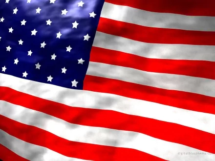A high-definition desktop wallpaper featuring the American flag, showcasing its vibrant red, white, and blue colors with stars and stripes elegantly flowing.