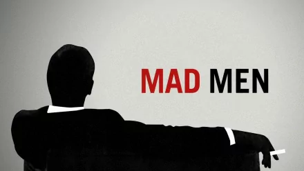 HD PC desktop wallpaper featuring a silhouette of a man sitting on a couch with the red and black Mad Men TV show title on a gray background.