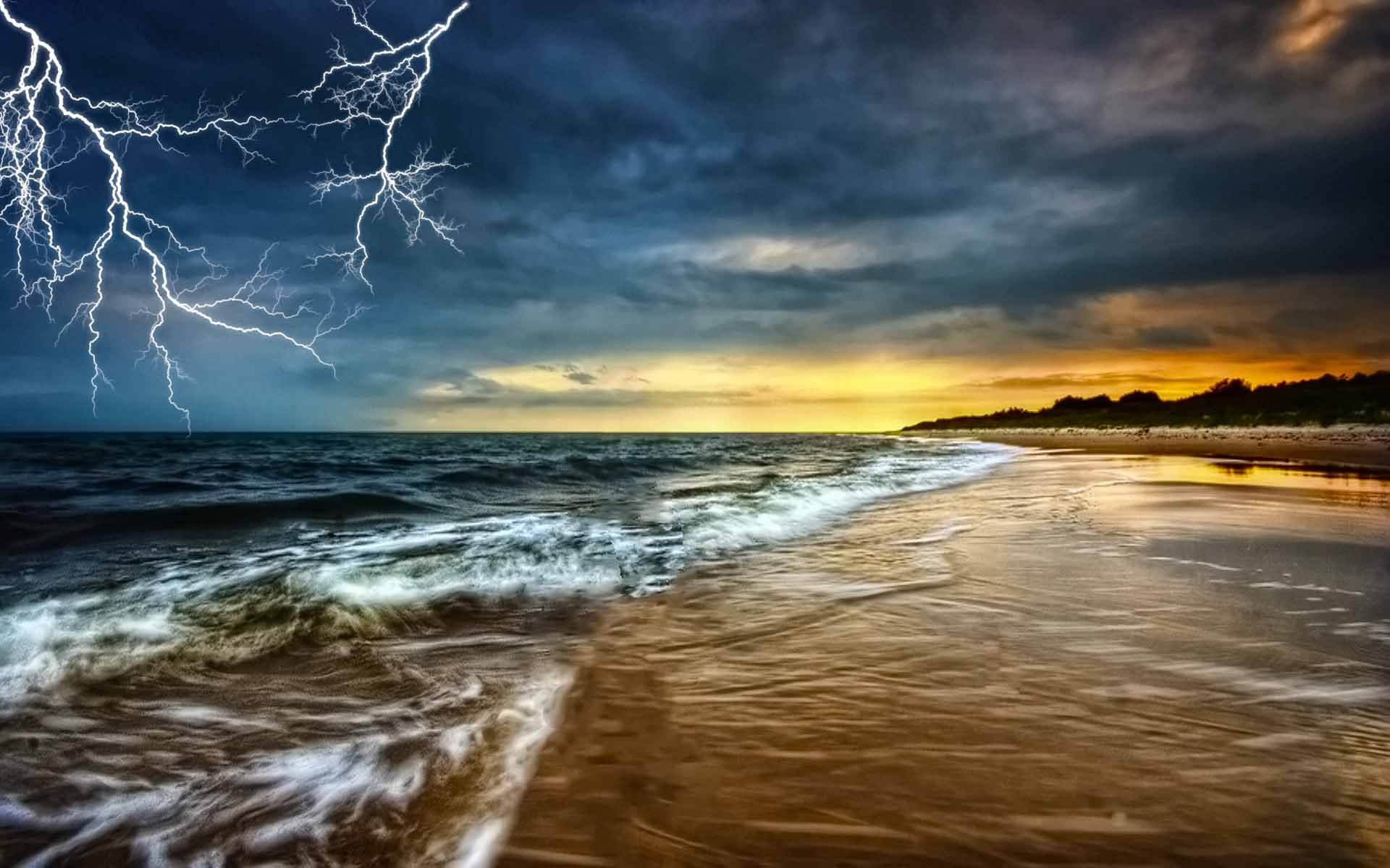 HD photography desktop wallpaper capturing vibrant lightning striking over a turbulent ocean shoreline beneath a dramatic, cloudy sunset sky.