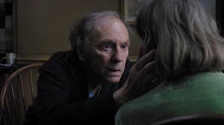 HD movie still from Amour: intimate close-up of an elderly man tenderly touching an elderly woman's face, raw emotion and quiet intimacy, PC desktop wallpaper/background.