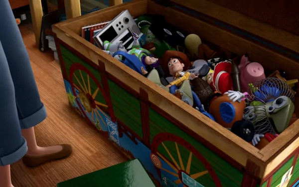HD desktop wallpaper featuring an animated Toy Story toy chest filled with iconic toys like Woody, Buzz Lightyear, and others from the movie.