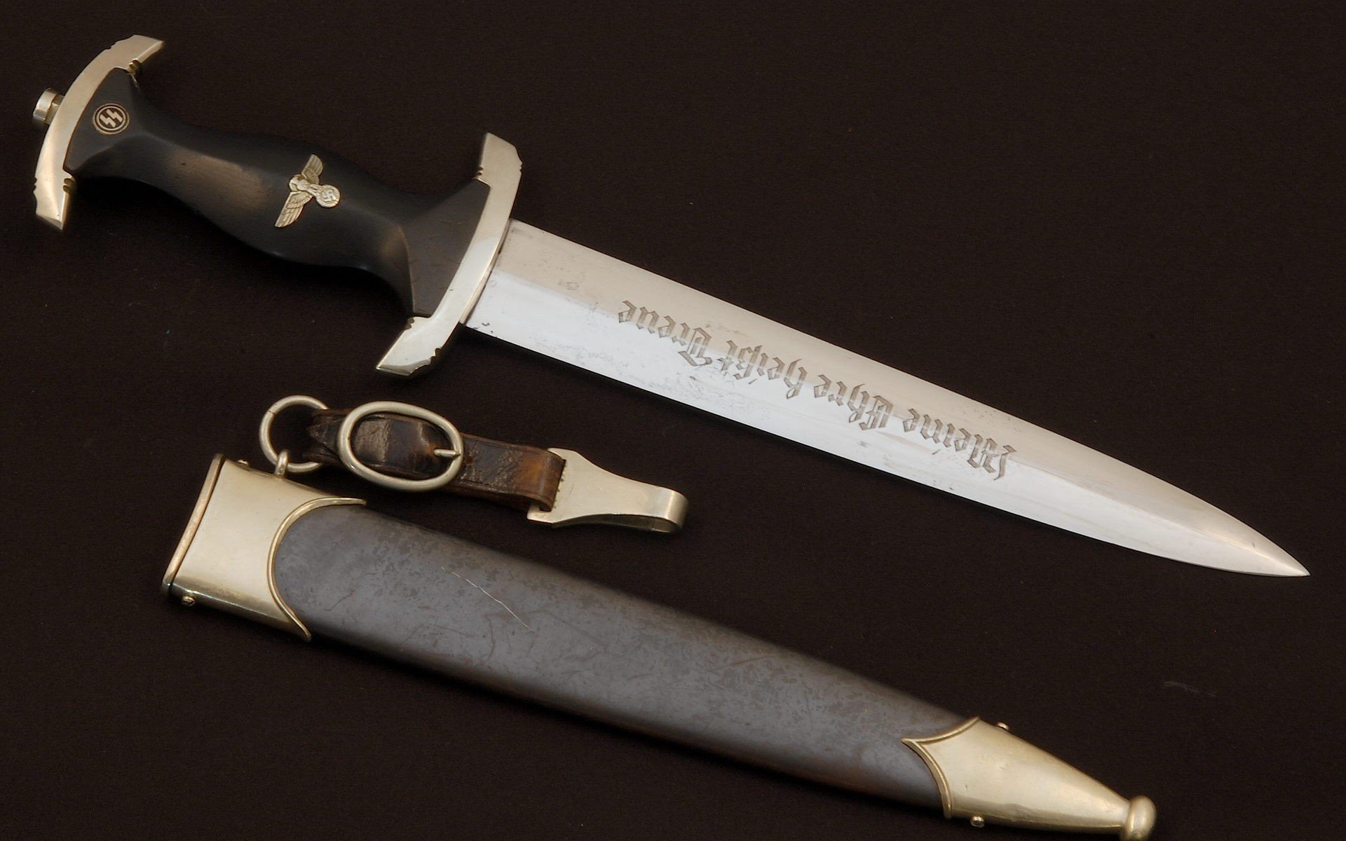 A detailed HD wallpaper featuring a decorative knife with an ornate handle and a sleek sheath, showcasing the artistry of man-made design.