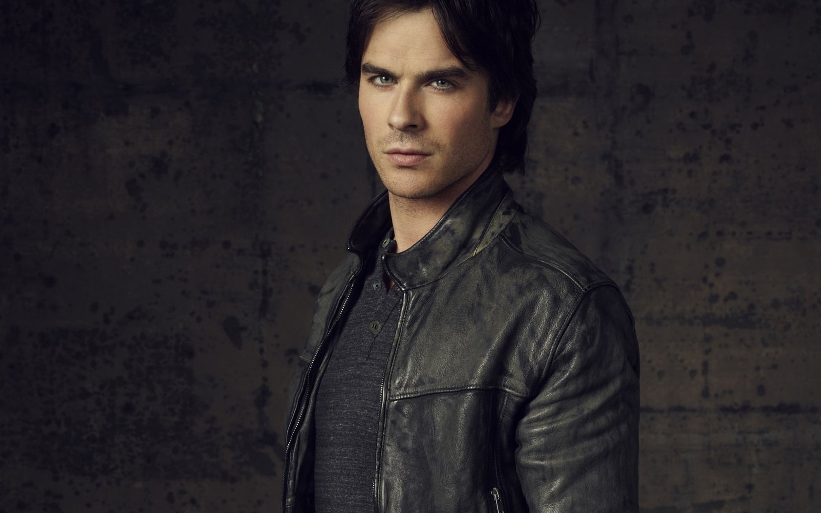 HD PC desktop wallpaper featuring celebrity Ian Somerhalder wearing a black leather jacket against a dark, textured background.