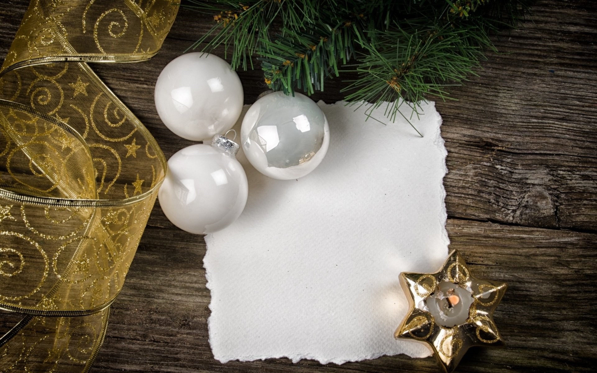 A cozy holiday scene featuring Christmas ornaments, including white and silver balls, a golden star candle, and a decorative ribbon, set against a rustic wooden background.