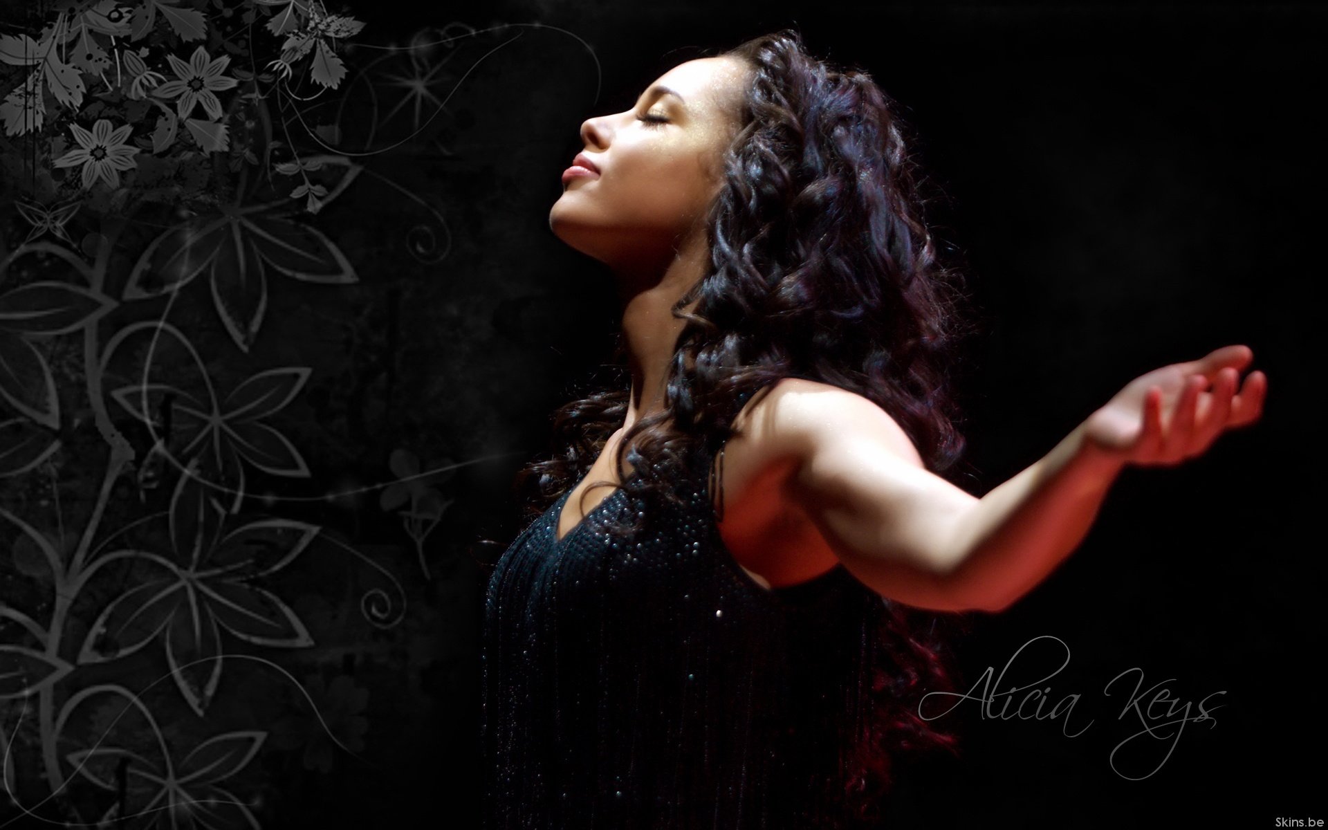 HD PC desktop wallpaper: music-themed portrait of a female singer, arms outstretched and head lifted, framed by dark floral textures and a soft spotlight.