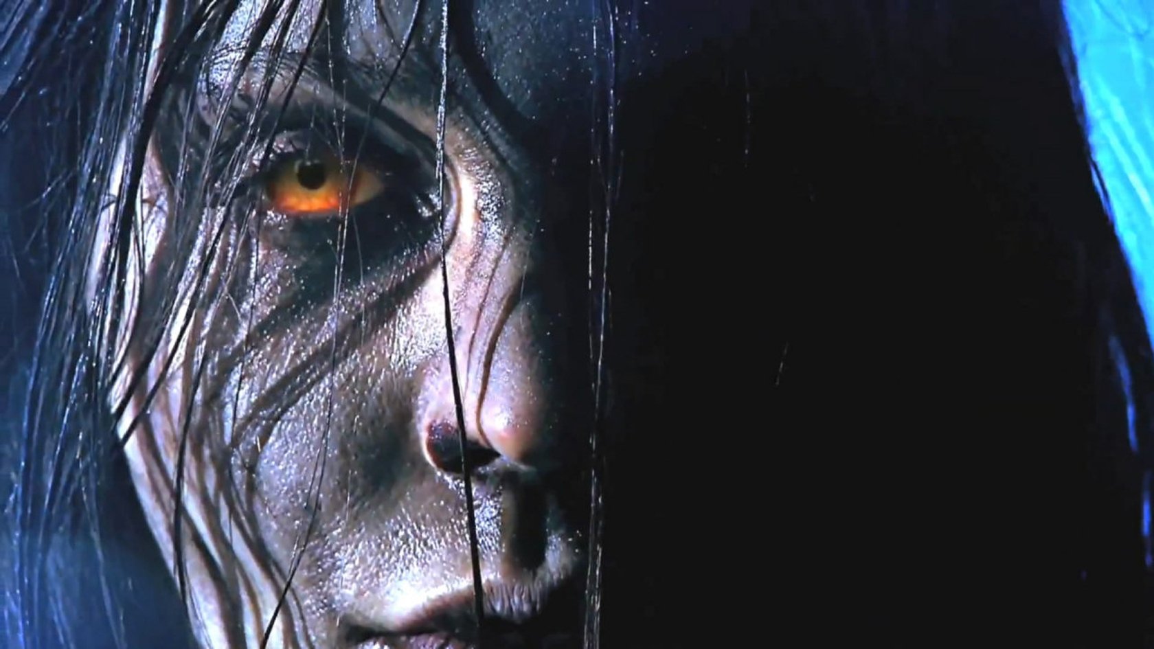 Close-up of a character’s intense face with glowing orange eye from the video game F.E.A.R. 3, featured as an HD PC desktop wallpaper and background.