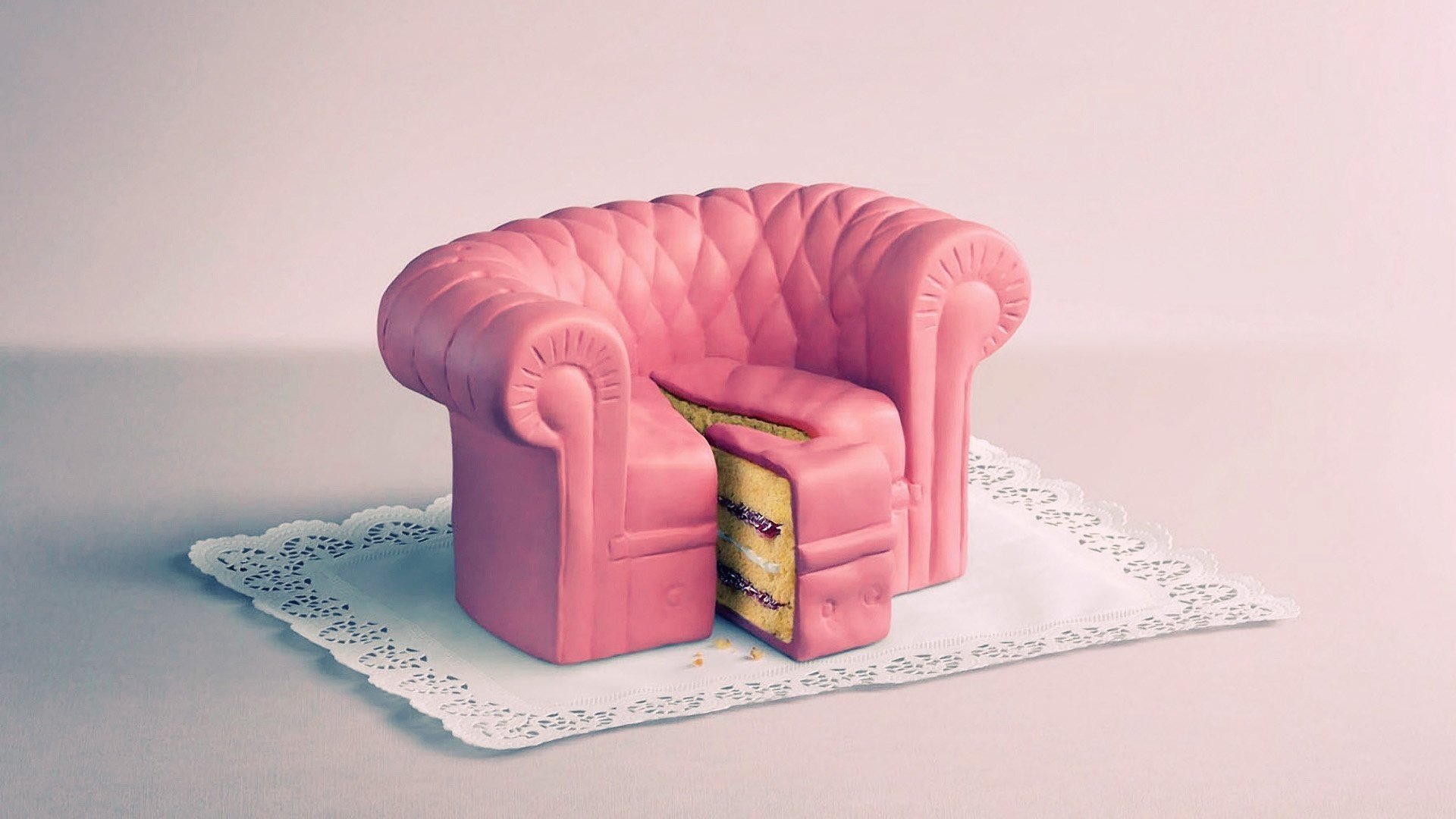 HD PC desktop wallpaper featuring a pink armchair designed as a layered cake with a slice removed, resting on a decorative doily.