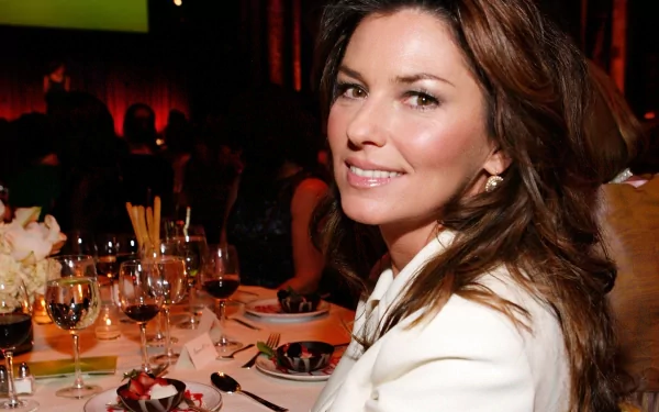 HD PC desktop wallpaper of a smiling female music artist at a candlelit dinner table, wearing a white jacket with warm ambient lighting and elegant place settings.