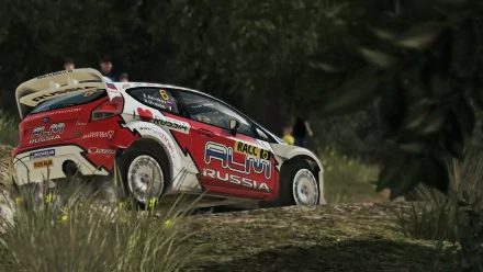 HD desktop wallpaper featuring a WRC 3 rally car speeding on a dusty trail with foliage in the background.