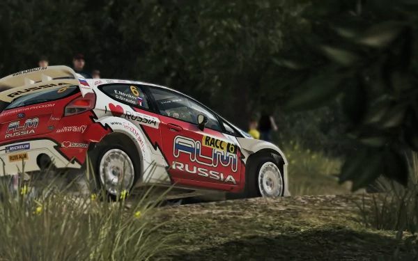 HD desktop wallpaper featuring a WRC 3 rally car speeding on a dusty trail with foliage in the background.