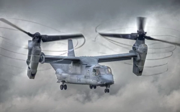 Military Bell Boeing V-22 Osprey aircraft in flight against a cloudy sky, captured in a high-definition desktop wallpaper image.