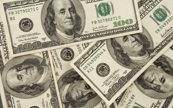 HD PC desktop wallpaper featuring a close-up of man-made 100-dollar bills spread out, showcasing detailed currency design and texture.