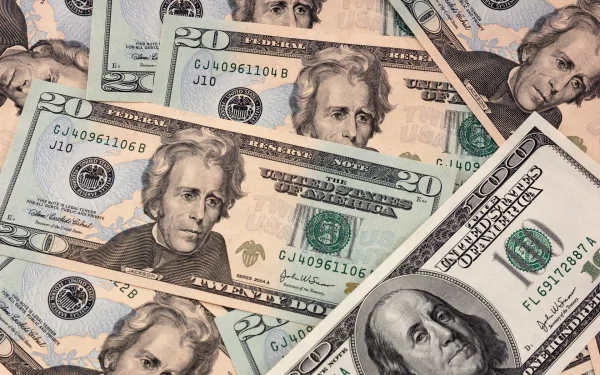 HD PC desktop wallpaper showing man-made US dollar bills scattered across the background, featuring $20 and $100 notes.