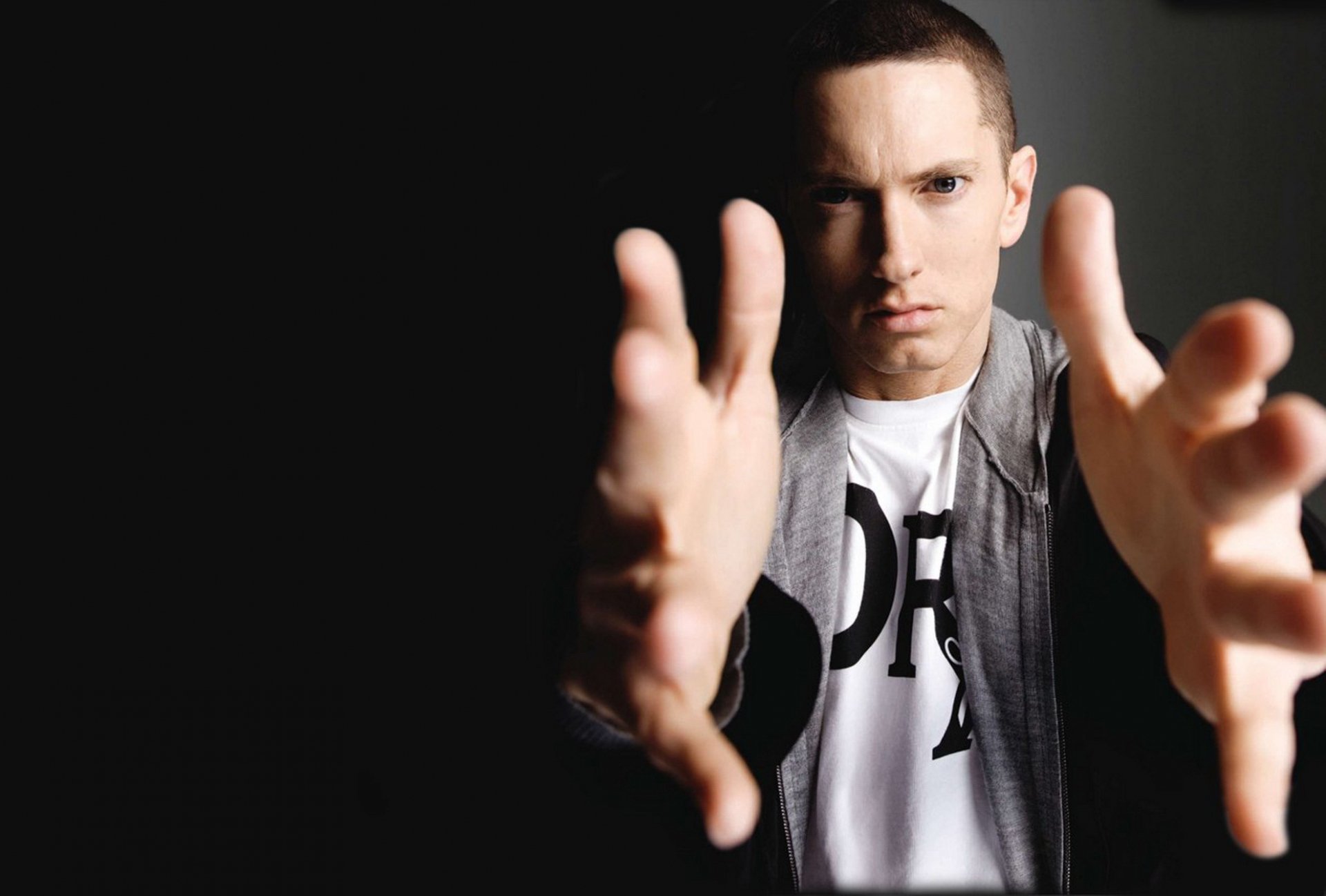 Eminem reaches out with outstretched hands in this striking HD PC desktop wallpaper, capturing the essence of his music and iconic presence.