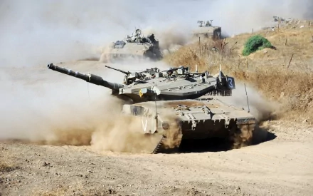 Military Merkava main battle tank kicking up dust on a dirt track, 2K Quad HD PC desktop wallpaper and background.