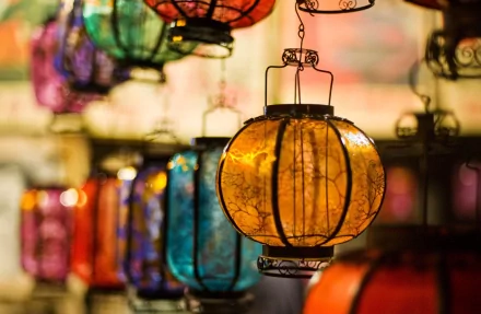 HD PC desktop wallpaper featuring colorful man-made lanterns hanging closely together, illuminating a warm and vibrant scene.