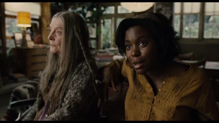 HD wallpaper featuring a scene from Children Of Men with two characters in a dimly lit room.