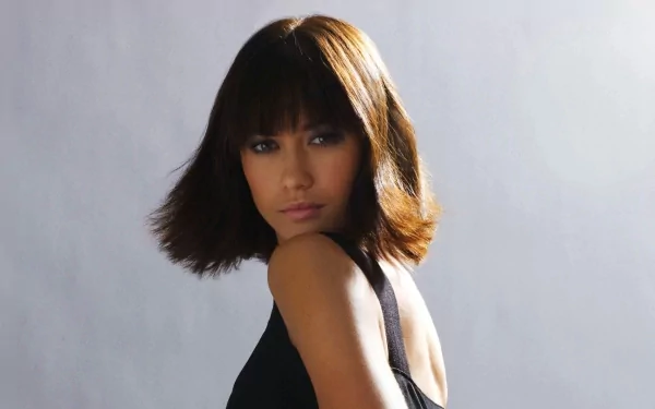 HD PC desktop wallpaper featuring celebrity Olga Kurylenko with a sleek bob haircut, wearing a black outfit against a neutral background.