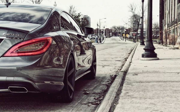 A Mercedes-Benz CLS63 parked on a city street, serving as a stylish HD desktop wallpaper background.