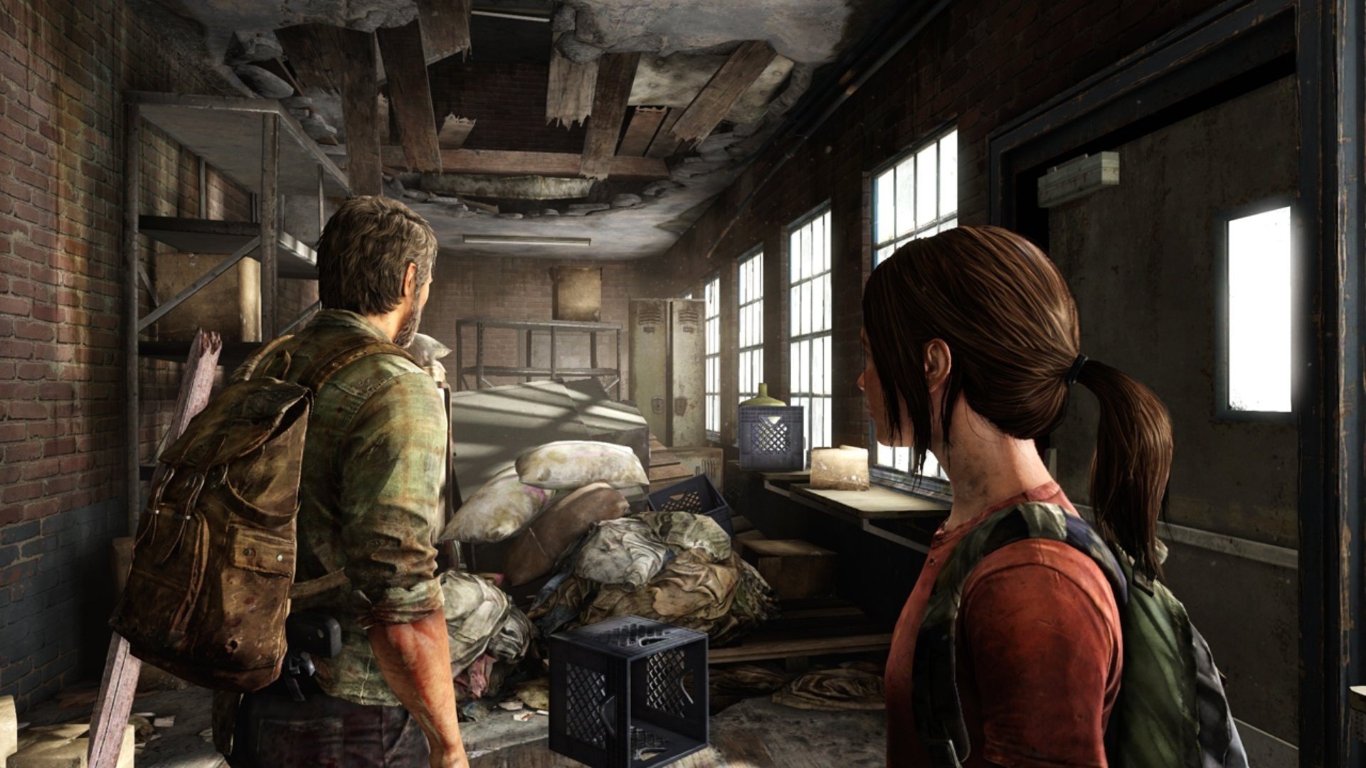HD desktop wallpaper featuring two characters from The Last Of Us exploring a dilapidated room filled with debris and sunlight streaming through windows.