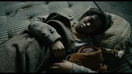 HD desktop wallpaper from Children Of Men featuring a woman and a newborn resting, embodying the film's poignant themes.