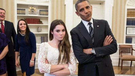 HD desktop wallpaper featuring a person mimicking a playful expression alongside another smiling person in a formal setting.