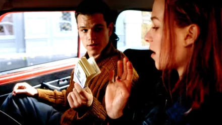 HD wallpaper from The Bourne Identity featuring two characters in a tense conversation inside a car.