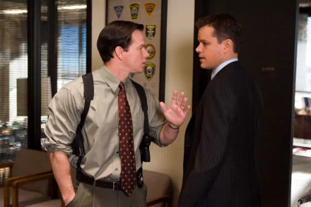 Mark Wahlberg and Matt Damon in a scene from the movie *The Departed*, captured in an HD desktop wallpaper, showcasing their intense characters in a gritty setting.