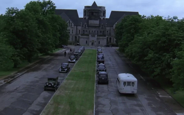 HD wallpaper based on The Shawshank Redemption, featuring the prison exterior with vehicles aligned on the driveway.