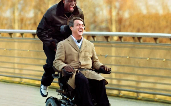 HD desktop wallpaper featuring two men, one pushing the other in a wheelchair, both with joyful expressions, from Intouchables.