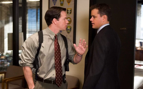 Mark Wahlberg and Matt Damon in a scene from the movie *The Departed*, captured in an HD desktop wallpaper, showcasing their intense characters in a gritty setting.