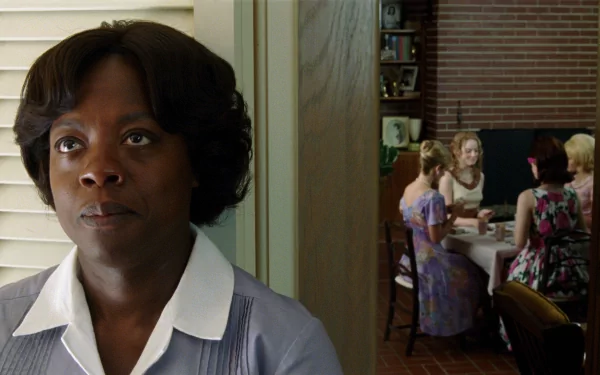 HD desktop wallpaper from The Help featuring a woman in the foreground and a group seated at a table in the background.