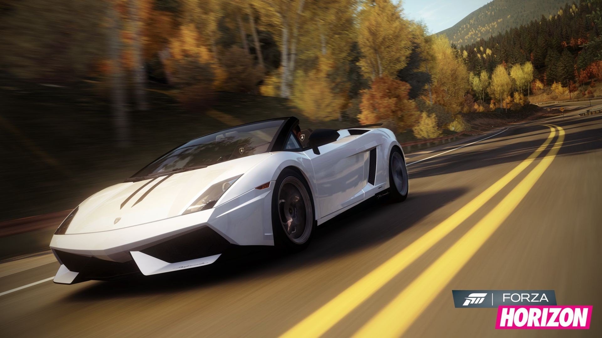 HD PC desktop wallpaper featuring a sleek white sports car racing down a mountain road in the video game Forza Horizon with autumn trees in the background.
