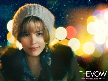 HD PC desktop wallpaper featuring Rachel McAdams from the movie The Vow, with a cozy winter hat and blurred colorful lights in the background.