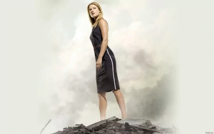 HD PC desktop wallpaper featuring celebrity Ali Larter standing on rocky terrain against a smoky, neutral background.
