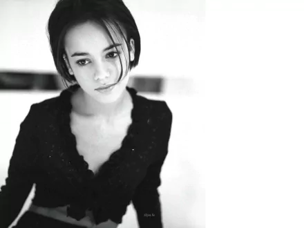 Black and white HD desktop wallpaper featuring a close-up portrait of Alizée, highlighting her serene expression in a music-themed background.