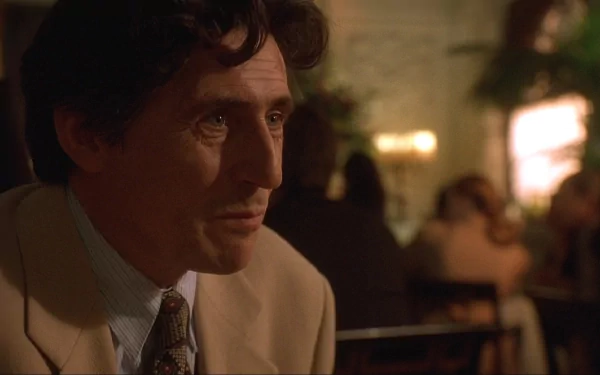HD desktop wallpaper featuring a still of Gabriel Byrne from The Usual Suspects in a dimly lit restaurant setting.
