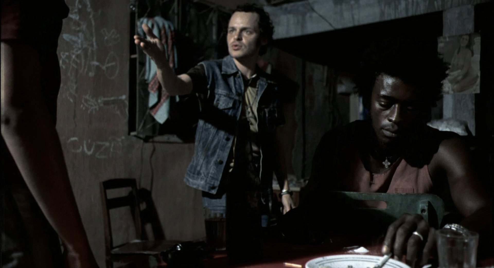 HD desktop wallpaper featuring a tense scene from the movie City of God, with two characters in a dimly lit room.