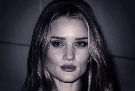 HD PC desktop wallpaper featuring a close-up portrait of celebrity Rosie Huntington-Whiteley with soft lighting and a dark background.