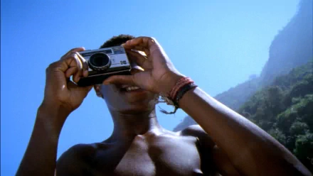 HD desktop wallpaper of a person taking a photo with a camera, referencing City of God.